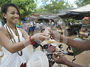 Smiling Woman Paying At Street Market