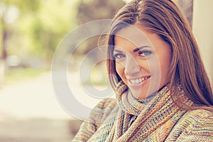 Smiling woman with perfect smile and white teeth in a park