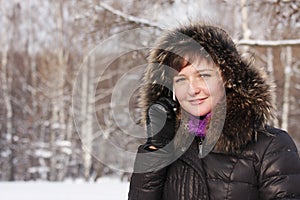 Smiling woman on phone in frosty day