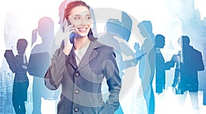 Smiling woman on phone and her business team