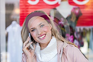 Smiling woman phoning with smartphone