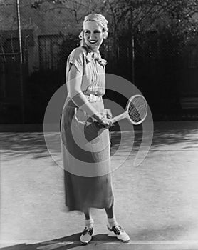 Smiling woman playing tennis