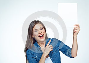 Smiling woman poining at white sign board.