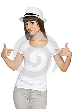 Smiling woman pointing at blank white t-shirt