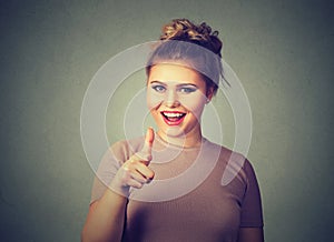 Smiling woman pointing finger at viewer camera gesture