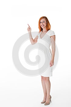 Smiling woman pointing to blank copyspace
