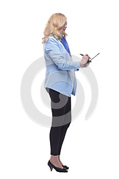 smiling woman pointing to a blank space in the clipboard .