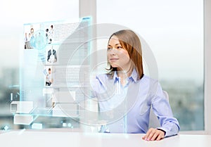 Smiling woman pointing to news on virtual screen