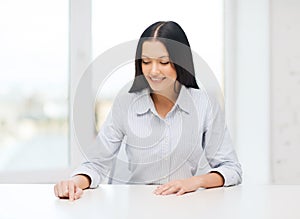 Smiling woman pointing to something imaginary