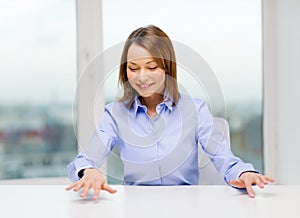 Smiling woman pointing to something imaginary