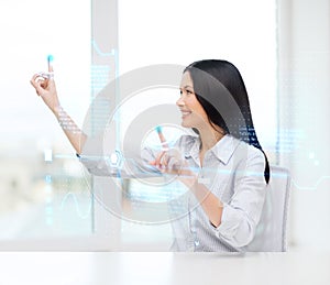 Smiling woman pointing to virtual screen