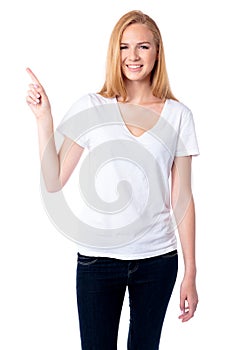 Smiling woman pointing up with her finger