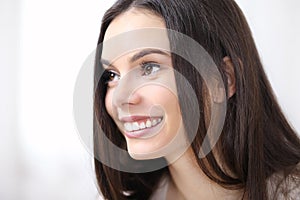 Smiling woman portrait in profile looking, isolated on white