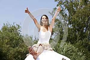 Smiling woman posing both thumbs up