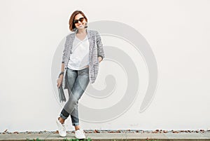 Smiling woman posing in casual city outfit in black and gray col photo