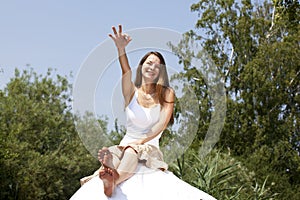 Smiling woman posing with the okay sign