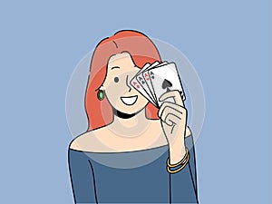 Smiling woman posing with playing cards in hands