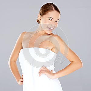 Smiling woman posing in a white towel