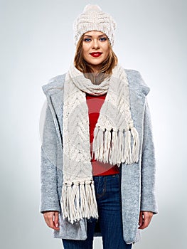Smiling woman posing in wool winter coat wearing knitted hat and scarf