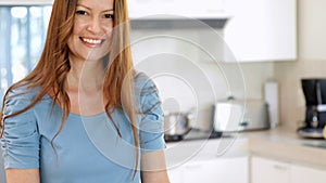 Smiling woman preparing vegetables on the chopping board