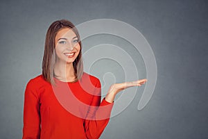 Smiling woman presenting copy space with open palm