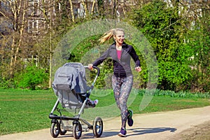 Smiling woman pushing baby buggy