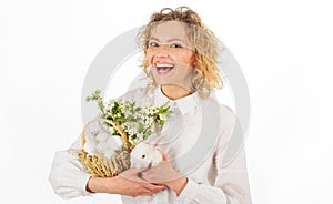 Smiling woman with rabbit and basket with eggs. Easter egg. Bunny. Happy Easters day.