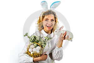 Smiling woman in rabbit ears with basket eggs and bunny. Happy Easter day. Easter funny emotions.