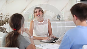 Smiling woman realtor discussing home choice with couple in real estate agency office, offering various options for