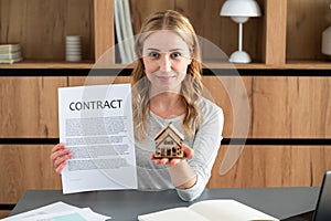 Smiling woman realtor selling apartment, offering to client, holding documents