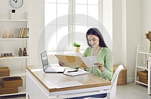 Smiling woman receive postal mail with important document, invitation or bank message.