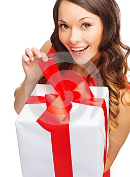 Smiling woman in red dress with gift box
