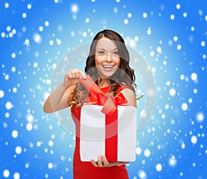 Smiling woman in red dress with gift box