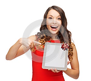 Smiling woman in red dress with tablet pc