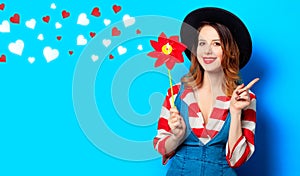 Smiling woman with red pinwheel with hearts