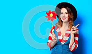 Smiling woman with red pinwheel