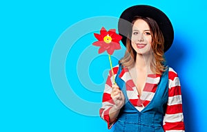 Smiling woman with red pinwheel