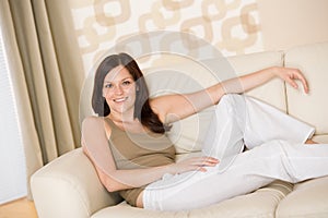 Smiling woman relax on sofa in lounge