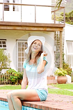 Smiling woman relaxing by pool