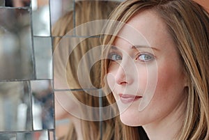 Smiling woman with relection in mirrors photo