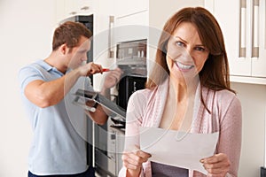 Smiling Woman With Repair Bill