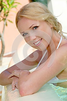 Smiling woman in resort pool