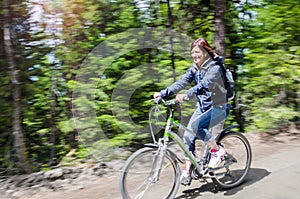 Smiling Woman Riding a Bicycle in Spring photo