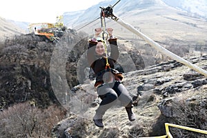 Smiling woman riding on zip line