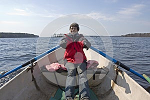 Smiling woman rowing on boat