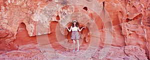 A Smiling Woman and a Sandstone Cliff