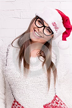 Smiling woman in Santa Claus hat.