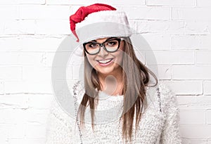 Smiling woman in Santa Claus hat.