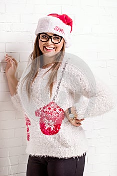 Smiling woman in Santa Claus hat.