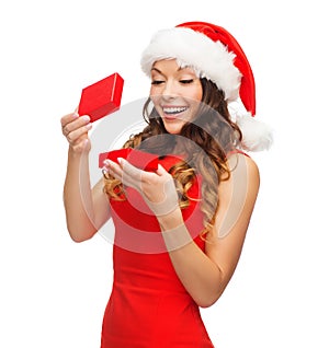 Smiling woman in santa helper hat with gift box